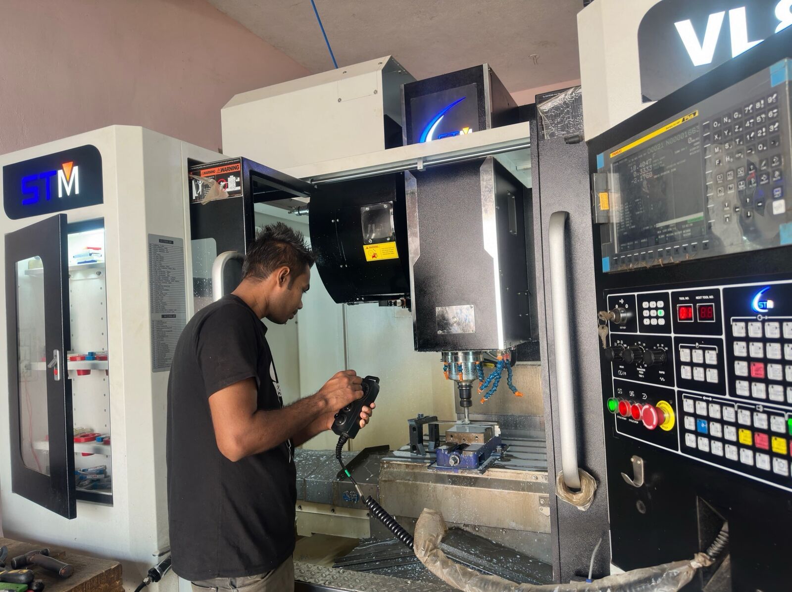 Machinist loading a component on the VMC table