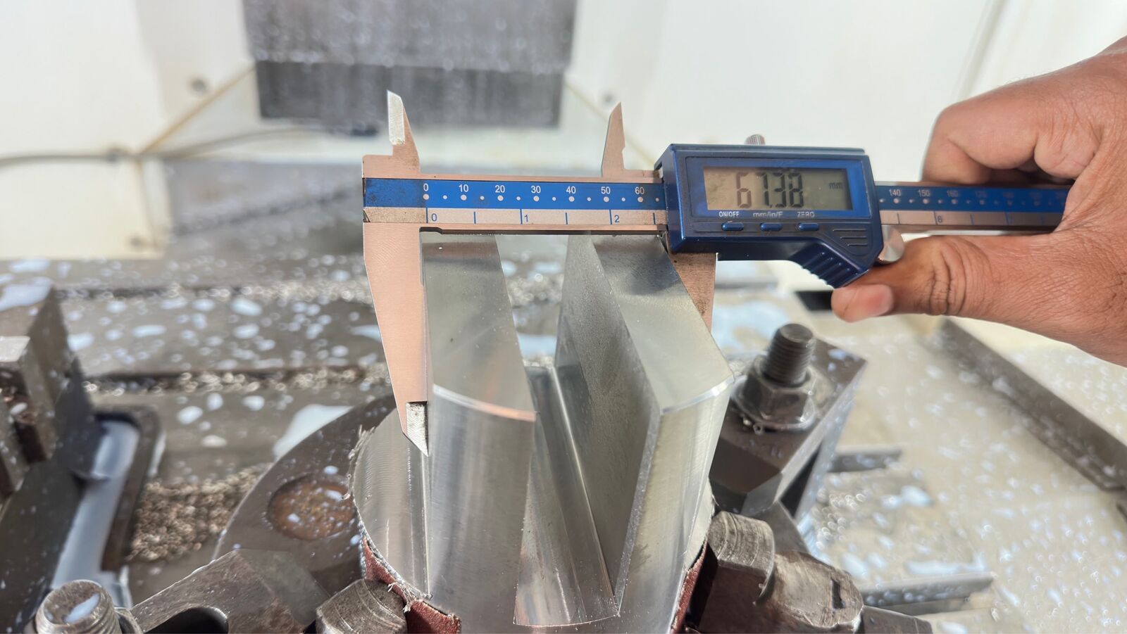 Final inspection of a machined component with caliper